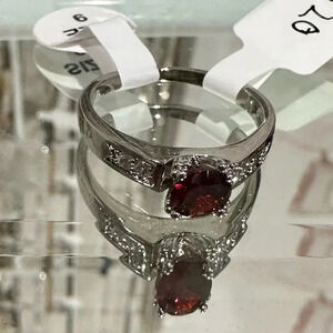 Beautiful new Size 9 ring. Silver rhinestone band with red stone women’s jewelry